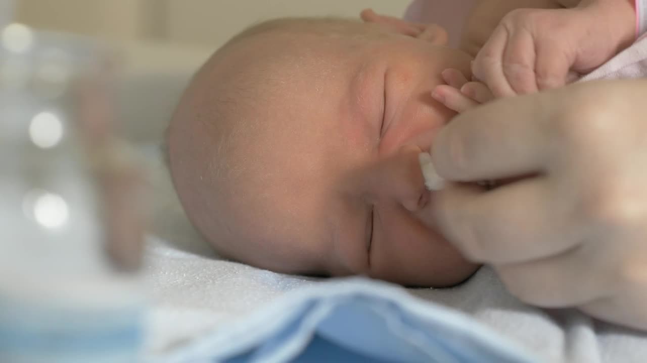 Newborn baby laying in a hospital