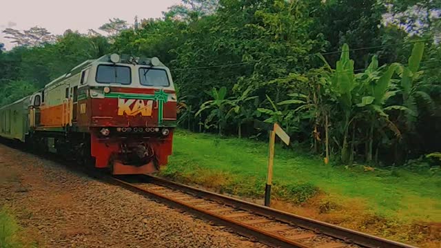 Indonesian train passes through the hills and crosses the bridge aesthetic video