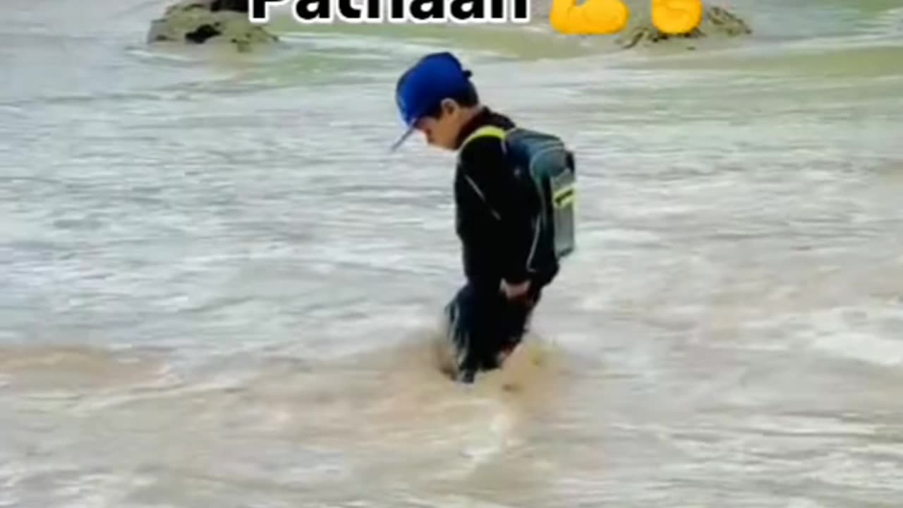 A little child is going to school to cross the river in Pakistan for his brightness future