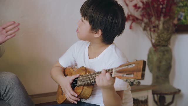 He plays the guitar with joy