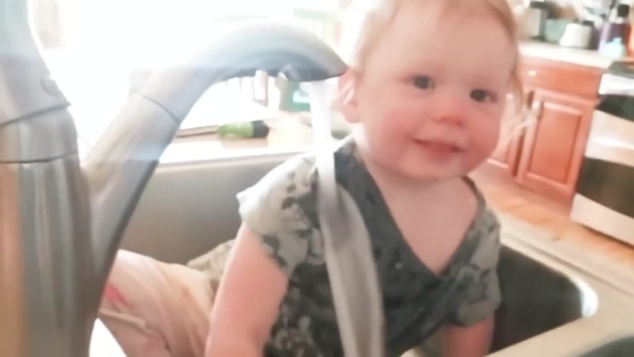 Baby just wants to drink some water, at least he tries to.