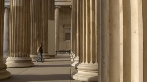 Man Walking Through Columns at British Museum