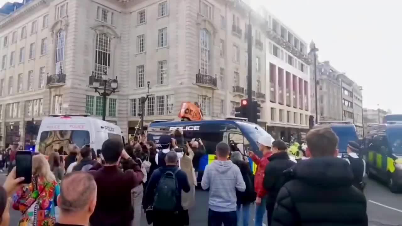 just stop oil supporter scales Metropolitan Police van, demands end to new oil a_3