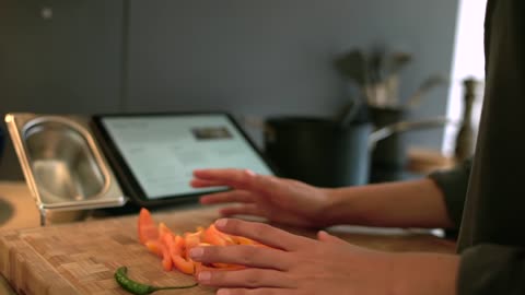 Close Up of Female Hands Placing Pepper In Saucepan-Close-up shot of female caucasian hands placing