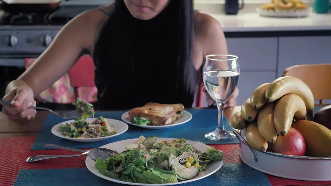 Girl eating salad in her kitchen dining room