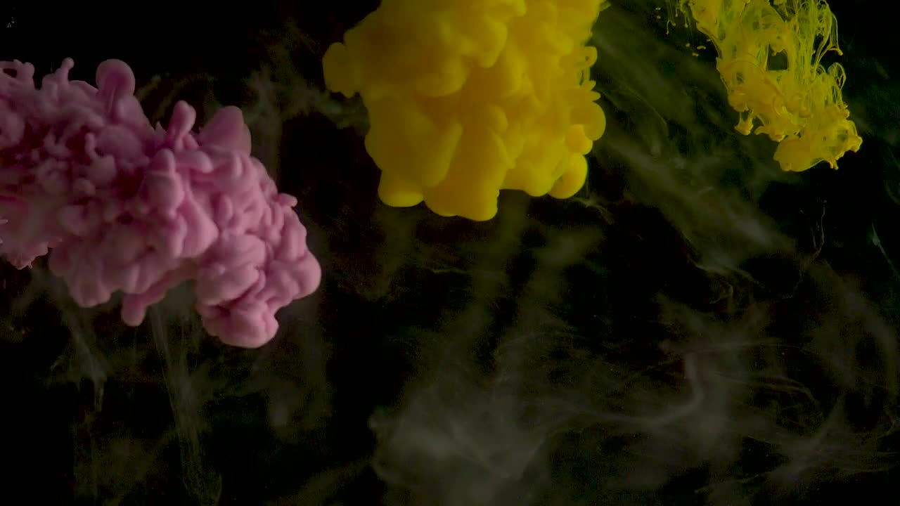 Pink and yellow ink underwater