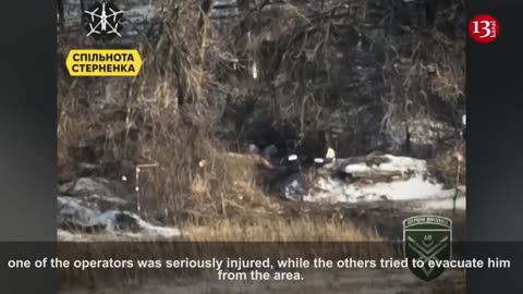 Russian soldiers rescue their wounded comrades who were attacked by drones in the forest