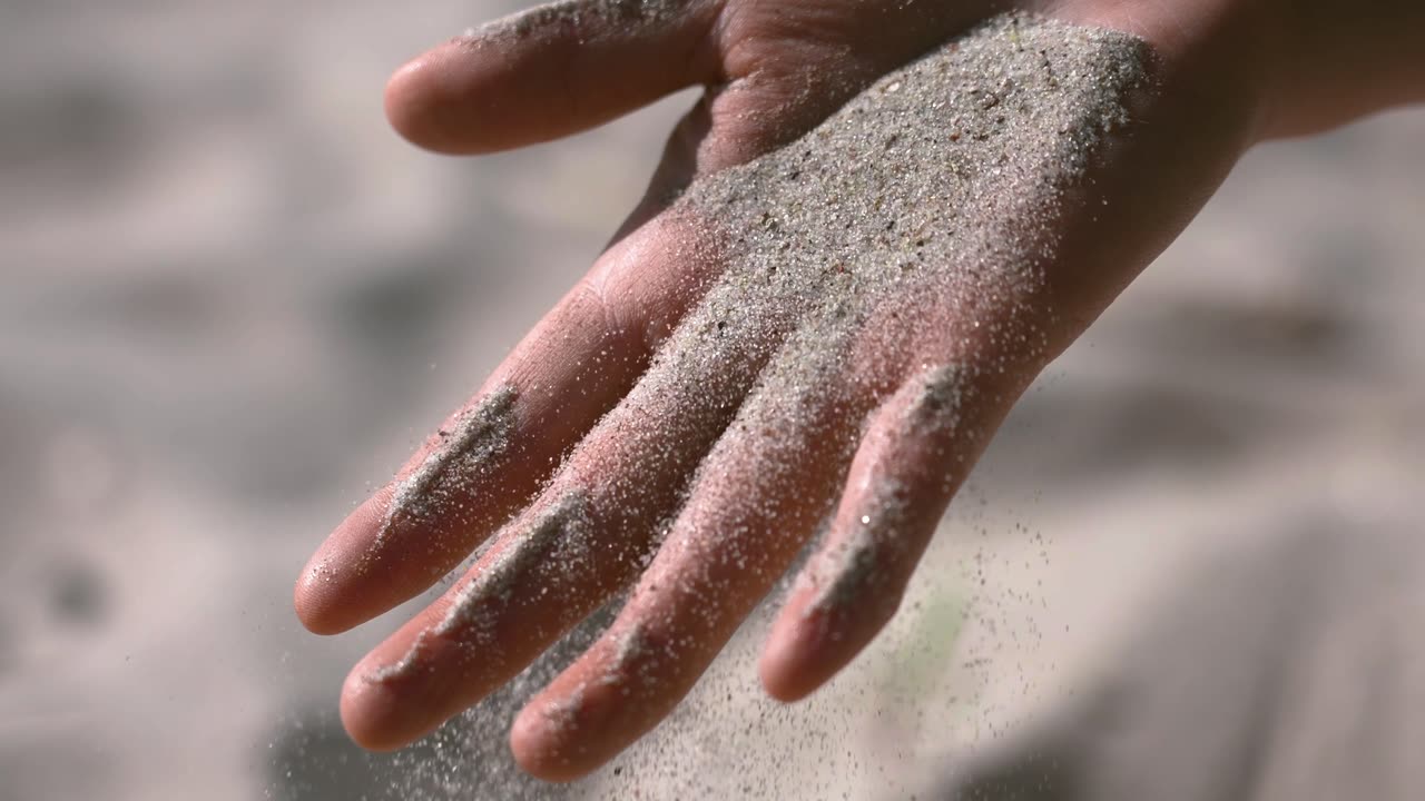 Sand on hand slow-motion video