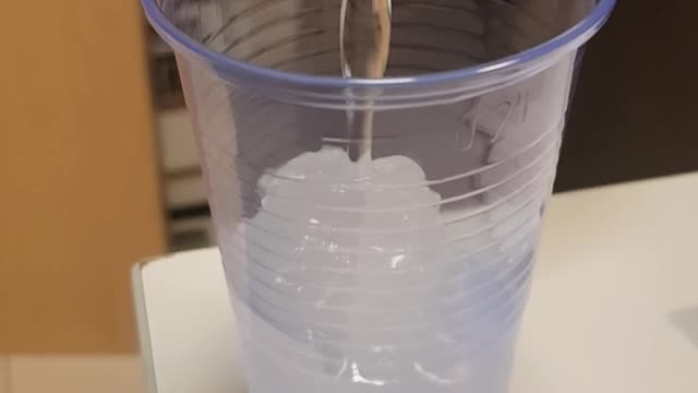 Pouring cold water into a cup