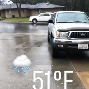 Guy grey shirt wearing sandals in the rain