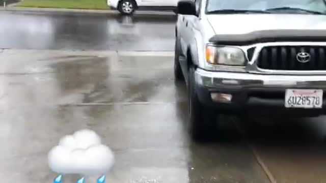 Guy grey shirt wearing sandals in the rain