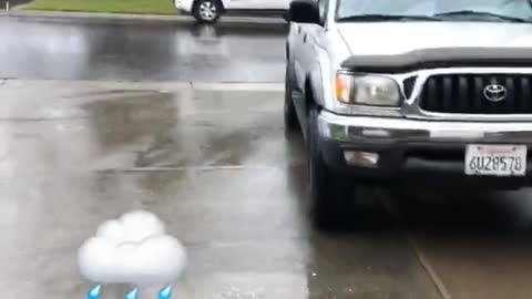 Guy grey shirt wearing sandals in the rain