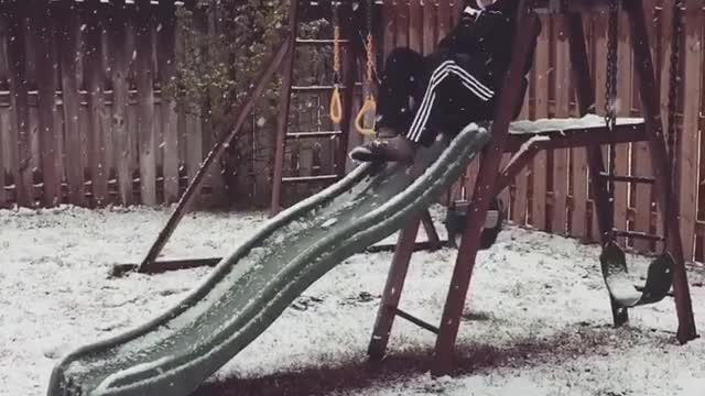 Collab copyright protection - mom goes down green slide in snow