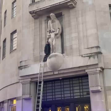 Someone has climbed onto the BBC building and smashing up the Eric Gill pedo statue