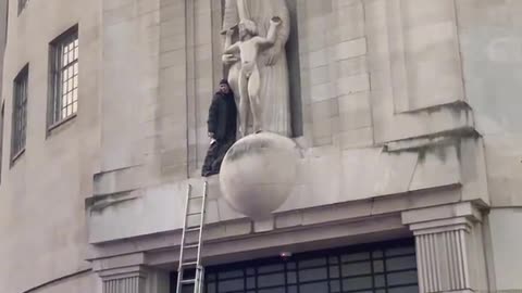 Someone has climbed onto the BBC building and smashing up the Eric Gill pedo statue