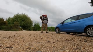 Putting hiking pack on.