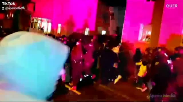 Police officer kicks peaceful person in the back from behind for no reason.