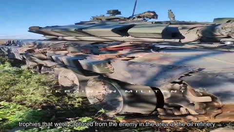 Fighters of the 54th brigade show a Russian tank and other trophies that were captured from the ene