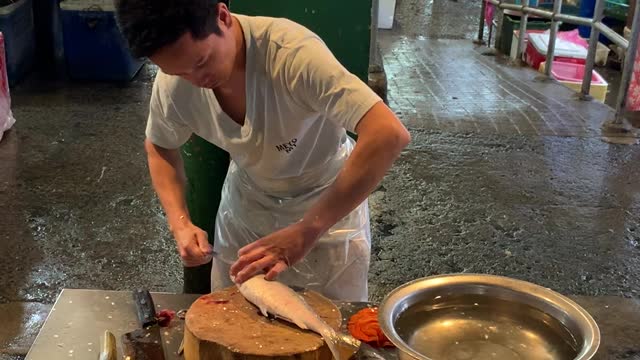 Man Prepares Milkfish in Philippine Market