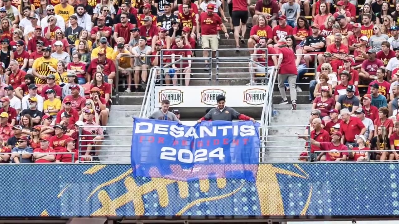 Team Meatball in their infinite wisdom decide to get these two dorks to hold a DeSantis flag...