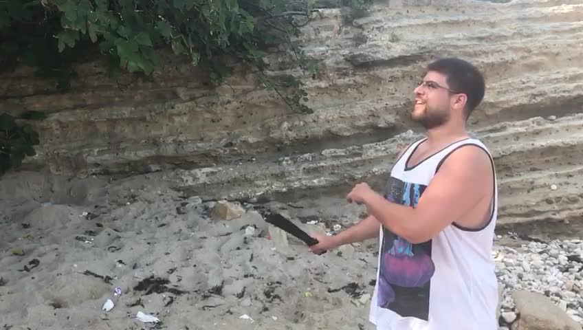 Guy slices tomato with machete and gets tomato thrown at him from behind