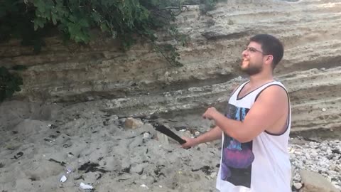 Guy slices tomato with machete and gets tomato thrown at him from behind