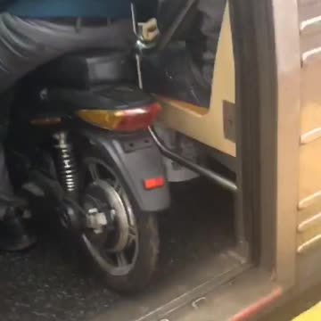 Man takes his motorcycle bike into a crowded subway train