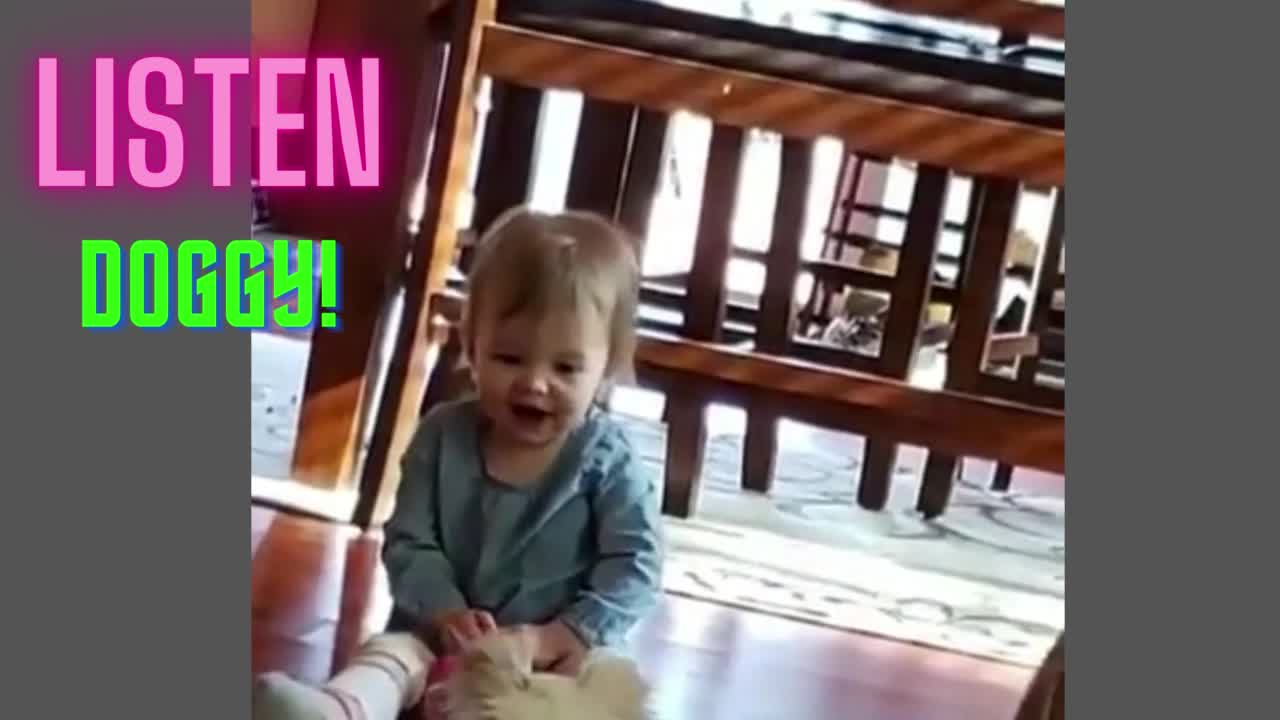 Cute baby Instructing her Dog.