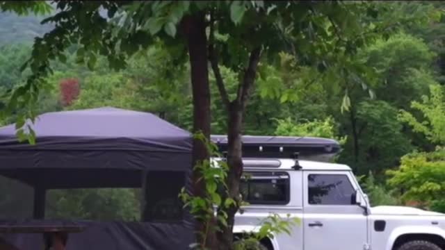 A man camping in the rain