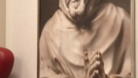 Man compares picture on phone to poster on wall