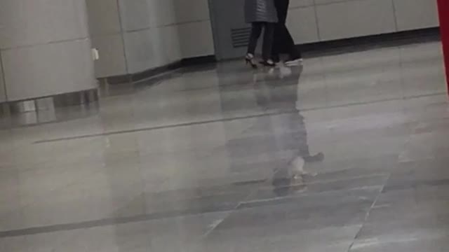 A couple ballroom dances on subway platform