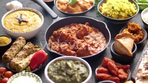 Various Indian dishes on a table. Spicy chicken Tikka Masala in iron pan. Delicious 😋