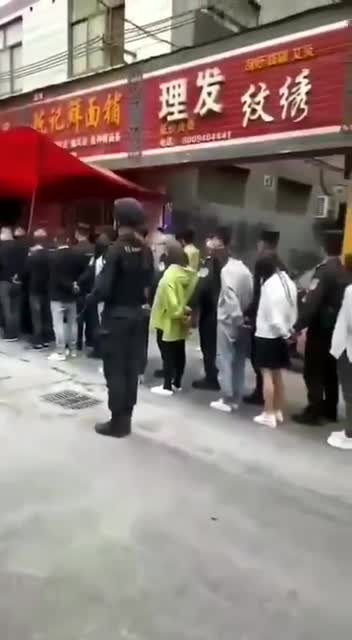 China uses handcuffs to bring to COVID testing