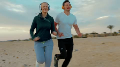 Couple out for a run on the beach