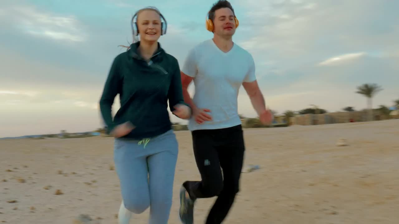 Couple out for a run on the beach