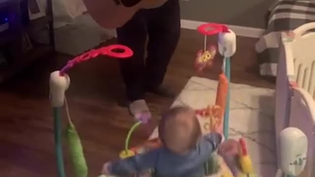 Baby Bounces to Music as Dad Plays White Stripes on Guitar