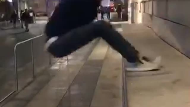 Guy in black jumps on concrete falls back