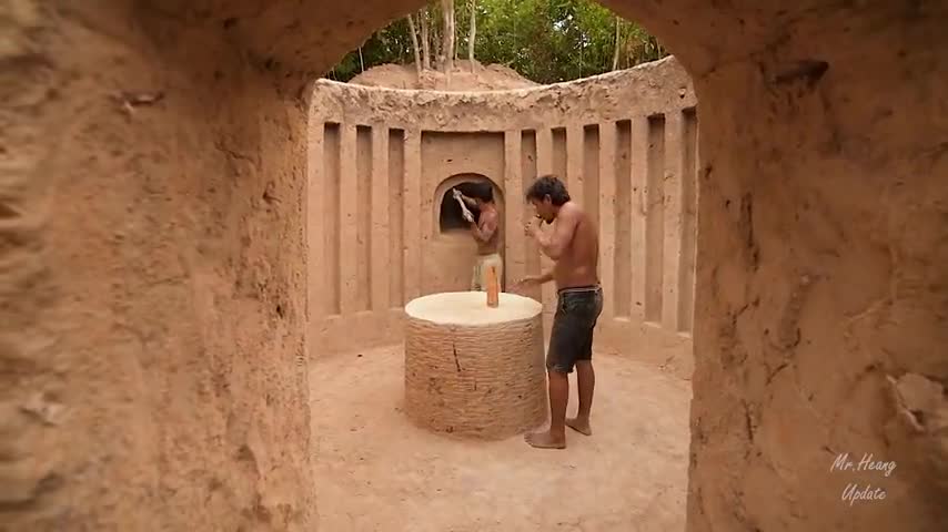 Building underground hut with grass roof & fireplace with clay