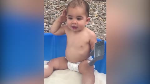 Baby having fun with sand with mom, cute