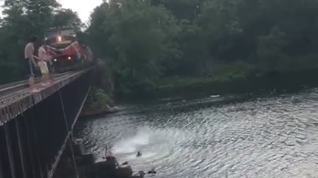 Jumping Off a Bridge Close to a Train as it Approaches