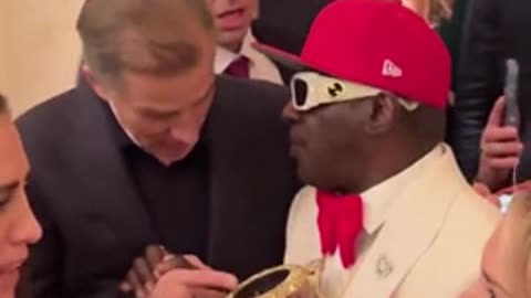 WOAH: Hunter Biden And Flavor Flav Appear To Exchange Numbers