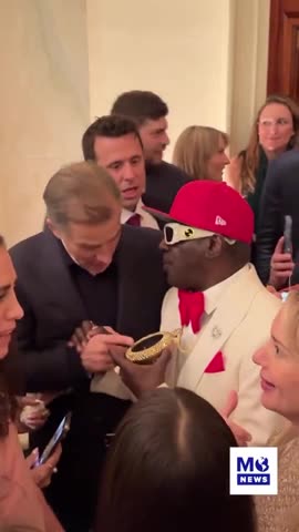 WOAH: Hunter Biden And Flavor Flav Appear To Exchange Numbers