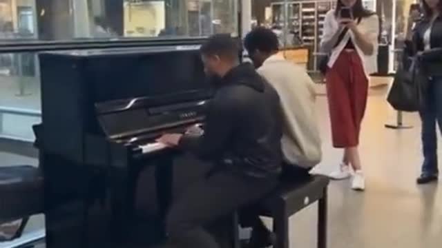 Two guys play interstellar theme at the mall