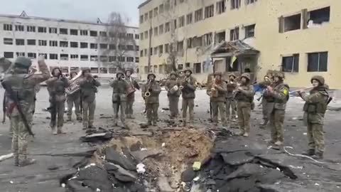 Ukrainian soldiers play the Ukrainian anthem