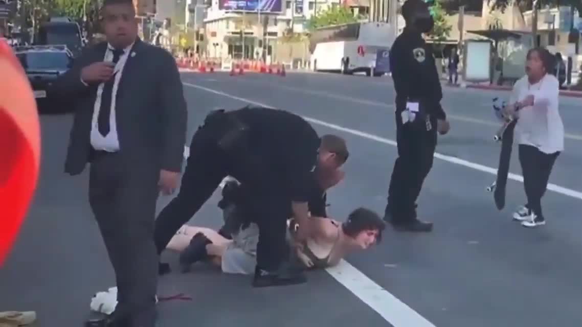 Secret Service takes down protesters while President Joe Biden motorcade drives down the street