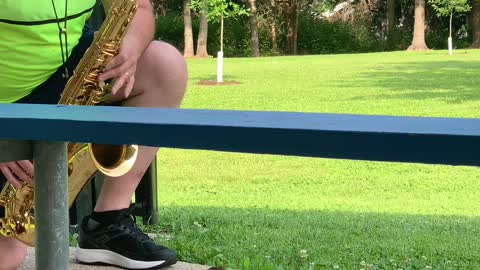 Squirrel Enjoys Listening to the Saxophone at the Park