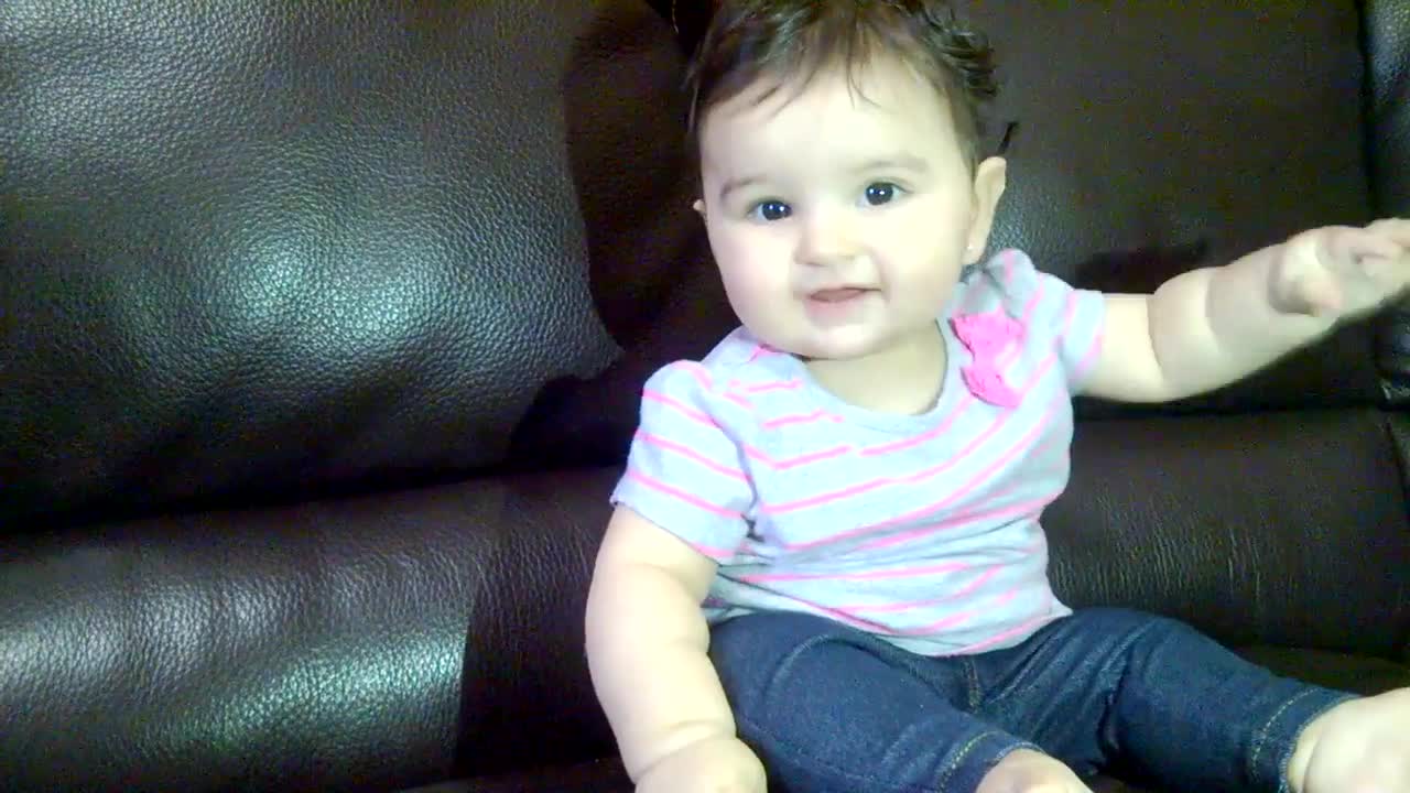 6 months old.. baby girl smiling for the camera