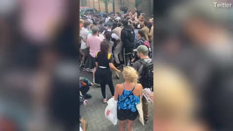 Immigration officers are forced to back down and release a suspect after protest