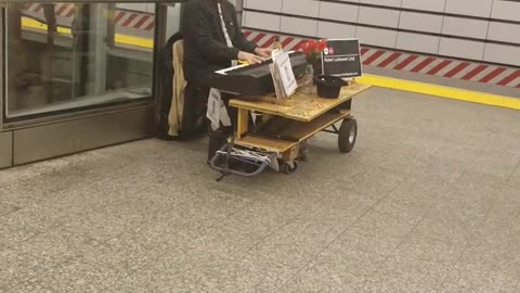 Piano man plays wedding song on the subway terminal