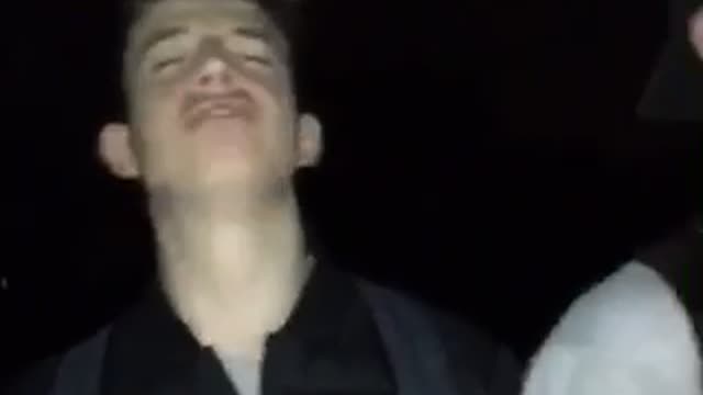 Group of guys sing anthem outside